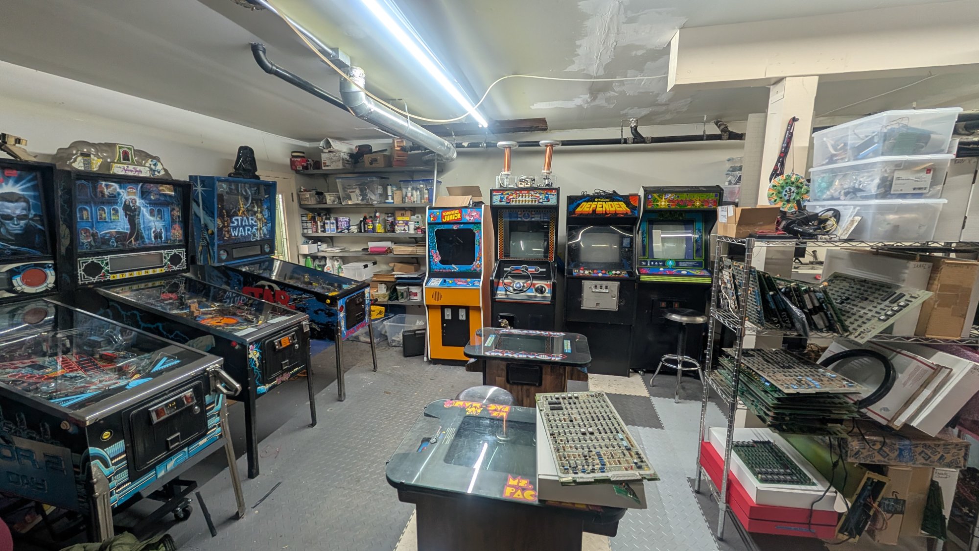 Arcade game room with Star Wars pinball, Addams Family pinball, Defender, Donkey Kong Jr cabinets and Ms. Pac-Man cocktail table at Woodside Arcade Repair